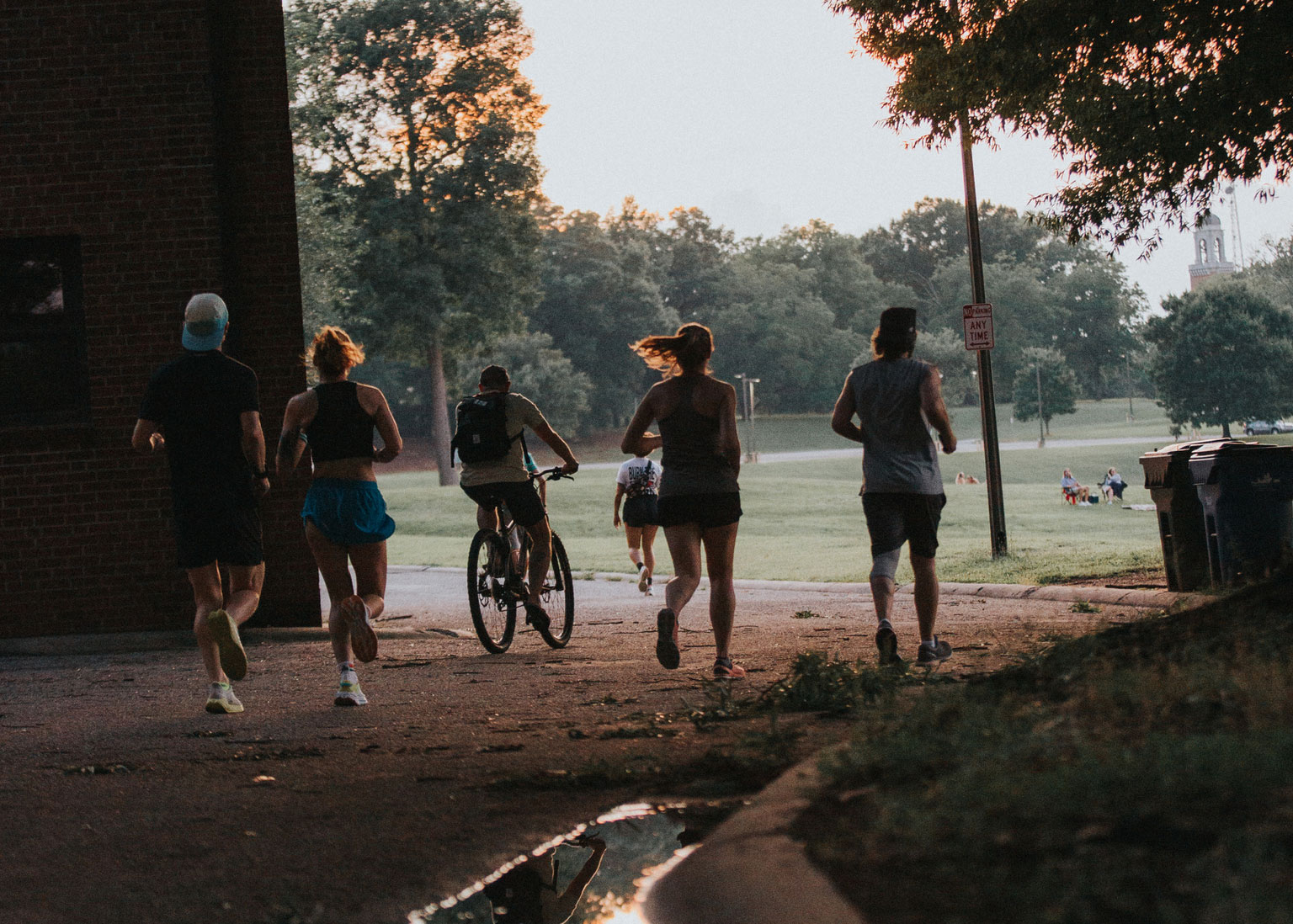 Runners and cyclist in a park