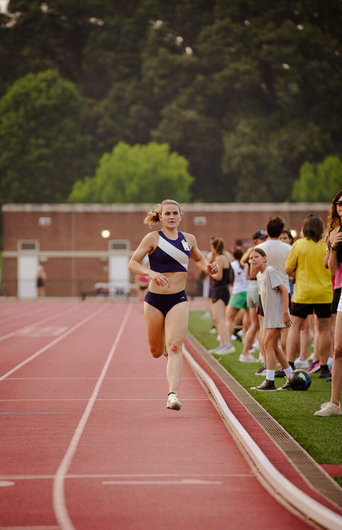 Girl finishing the championship mile on the track at Meredith college.