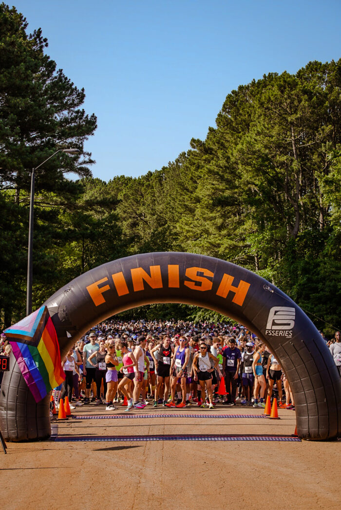 Crowd standing in front of finish line at Run For Love 2023.