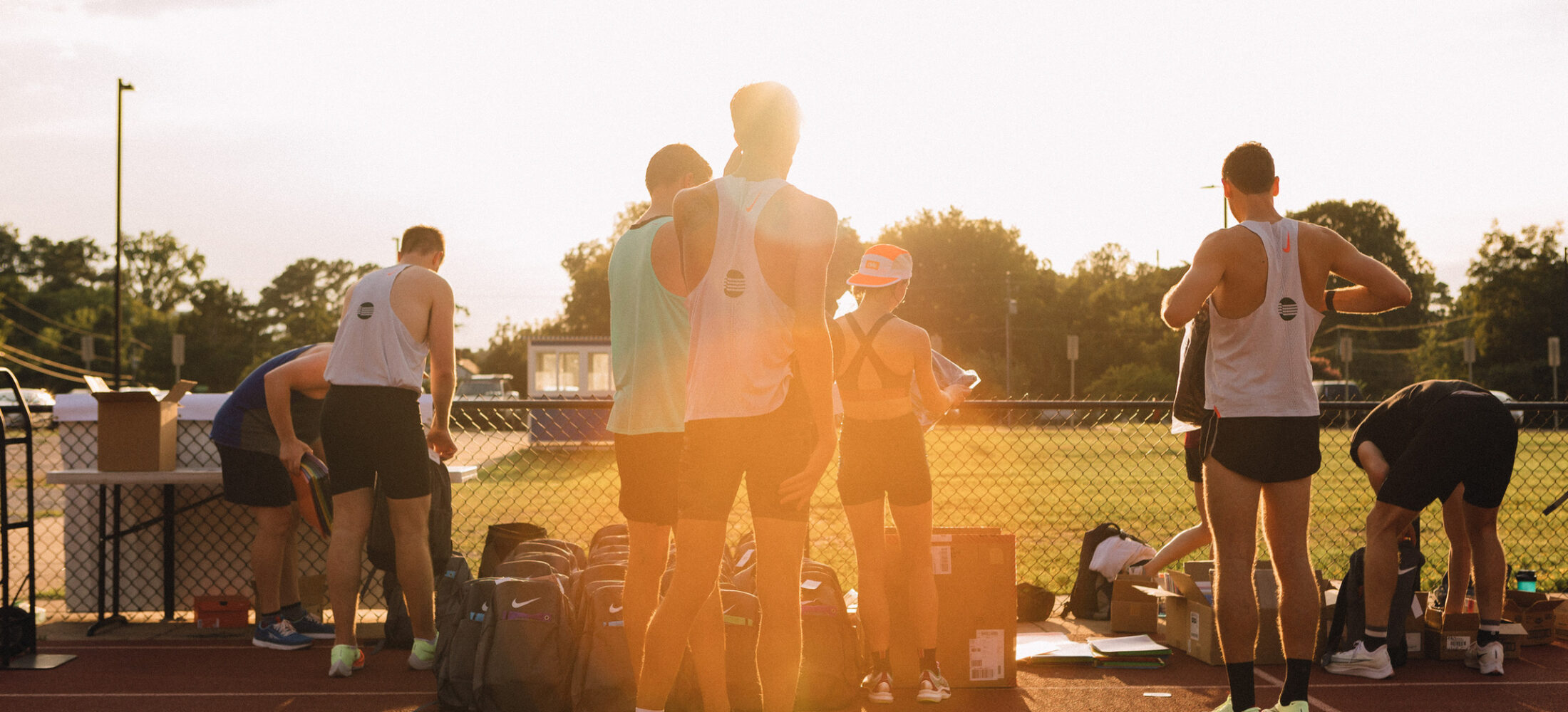 people filling backpacks